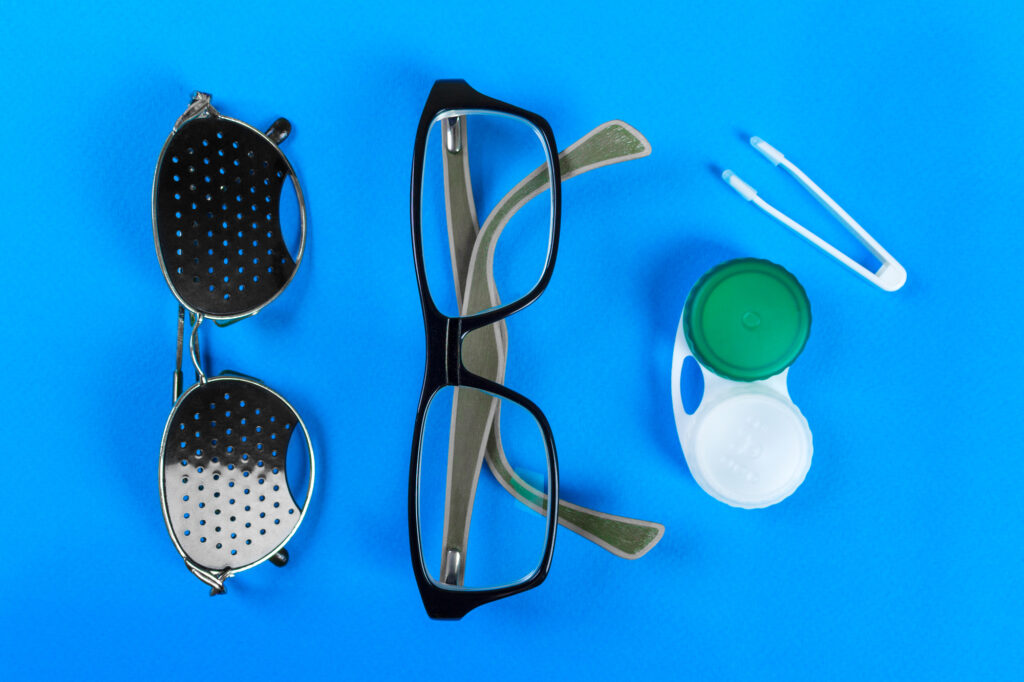 Do Pinhole Glasses Really Improve Vision? 2 A set of accessories for sight. including Pinhole glasses and normal eyeglasses and lenses