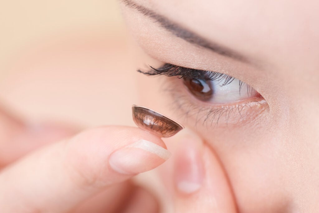 Colored Contacts for Astigmatism 10 Close up shot of woman tries to fit color contact lenses