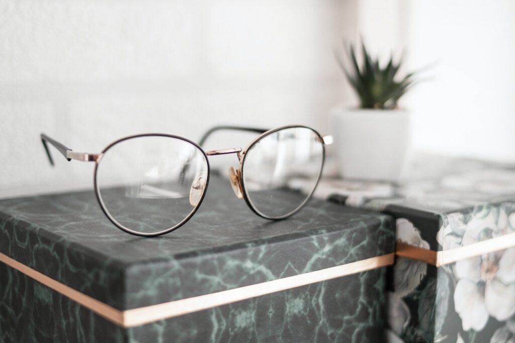 Trivex Eyeglass Lenses 2 focused shot of eyeglasses on top of a box