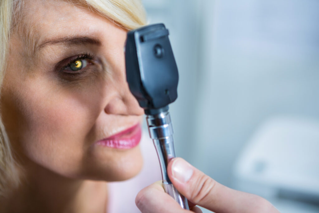 What Are the 3 Types of Eye Doctors? 5 Optometrist examining female patient through ophthalmoscope