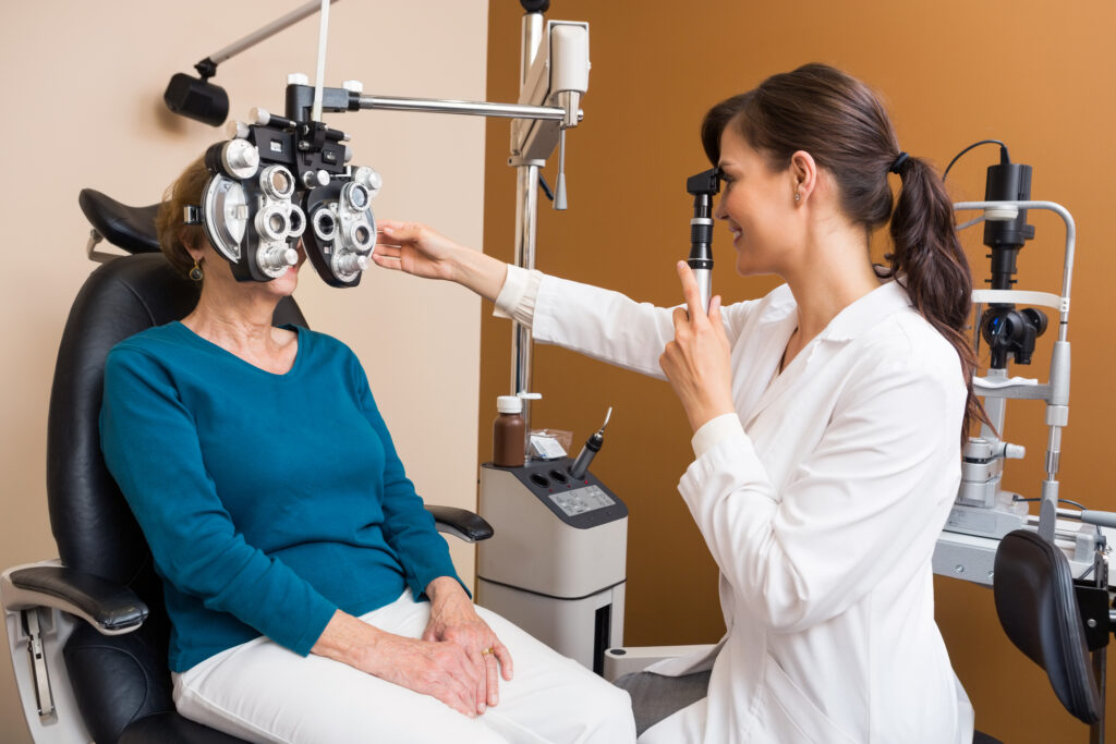 What Are the 3 Types of Eye Doctors? 6 Optometrist Examining Senior Womans Eyes using a Retinoscope