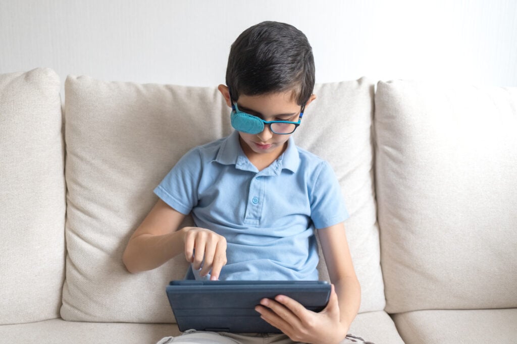 What to Expect With Amblyopia Surgery 3 Portrait of boy in glasses with amblyopia patch for glasses